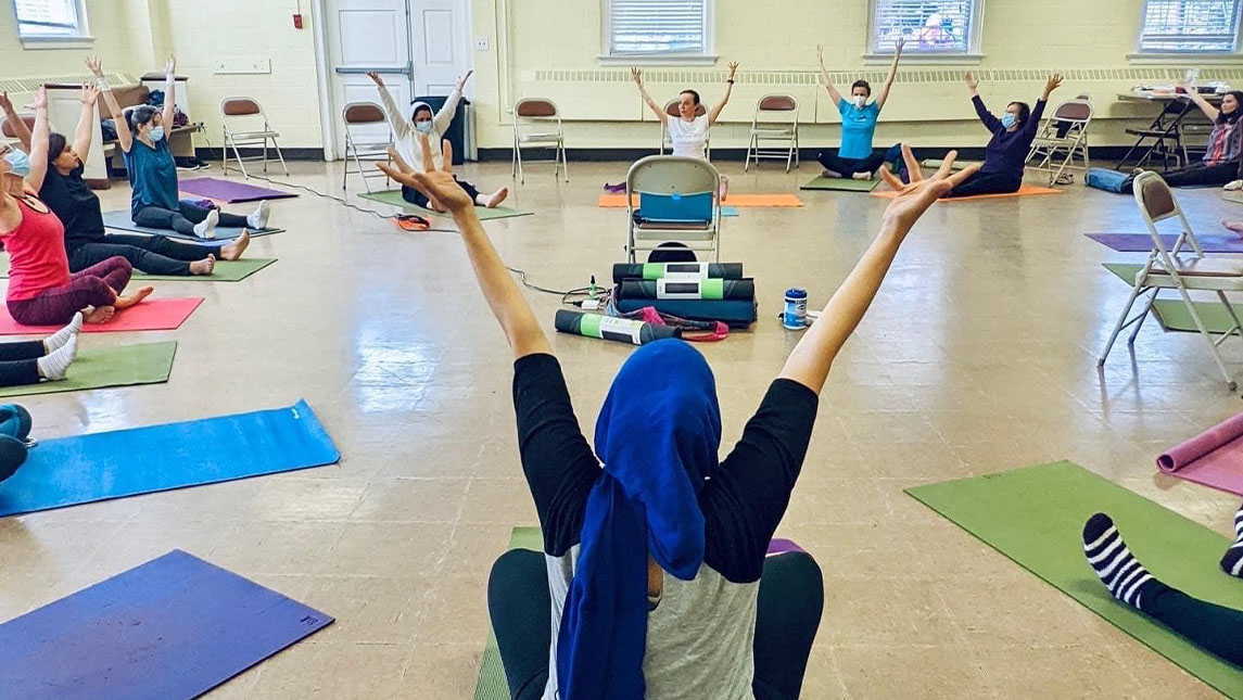 Kinesiology student uses yoga therapy to help area immigrants and refugees