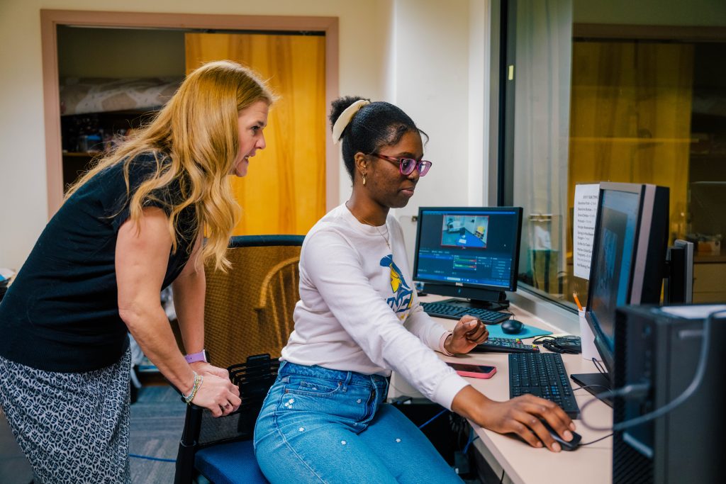 Dr. Shriver and Jayleen Gourdine at a computer.