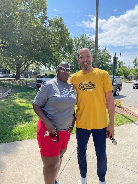 Two alumni and friends taking a picture before playing.