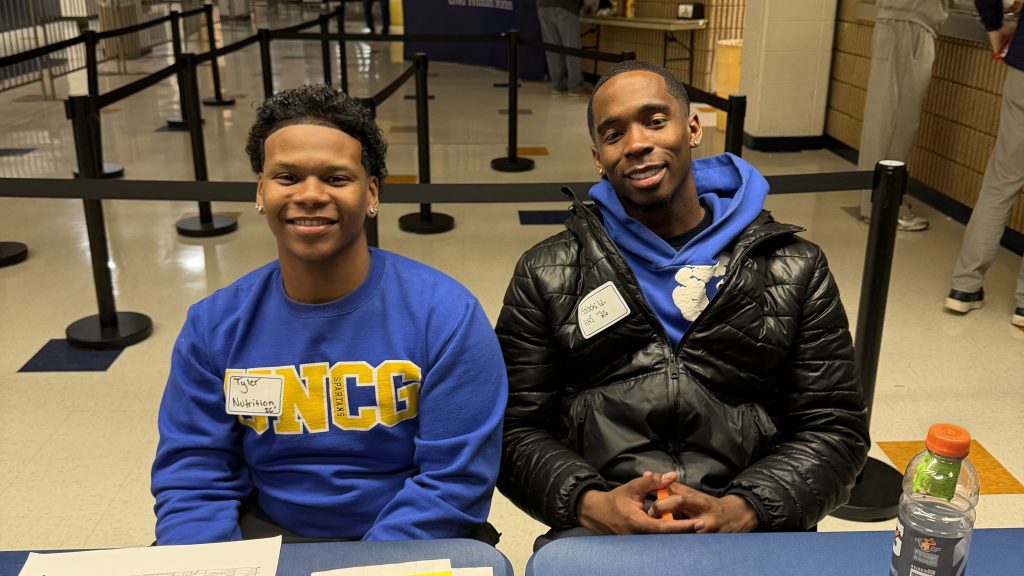 HHS Ambassadors at front desk during UNCG basketball game