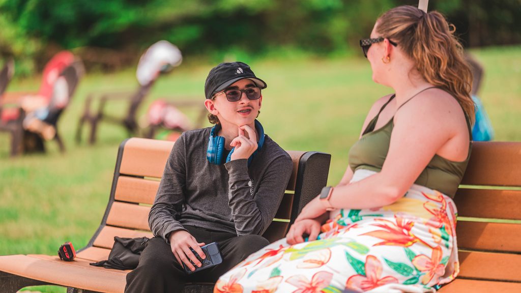 graduate students in the Department of Communication Sciences and Disorders speaks with camper at Camp SpeaksAlot